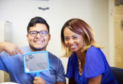 Image of a young man holding a mirror that says 