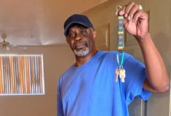 Man holds apartment keys in doorway